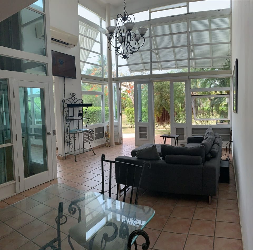 Living Room (dining room table perspective), note double doors and airy windows 