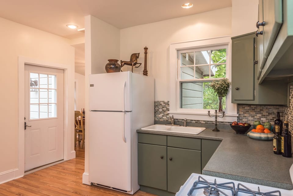 Kitchen with door leading to back deck area and back yard
