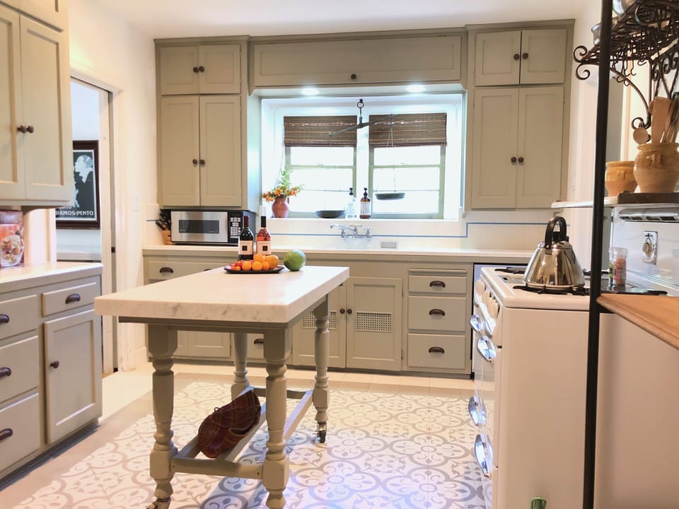 Fully stocked, renovated kitchen in main house with island on wheels.
