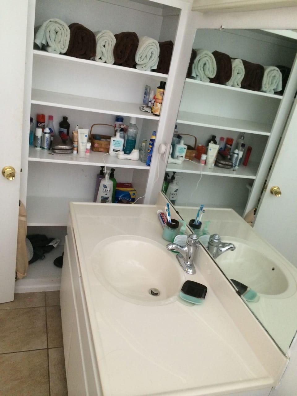 Towels and a blow dryer and other things you may need in the bathroom.