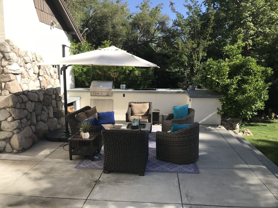 Outdoor lounge area with gas grill and wood/charcoal grill