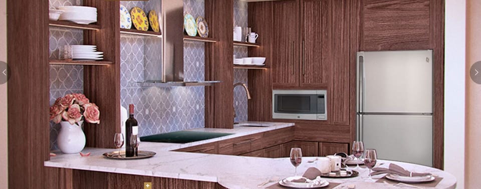 High end kitchen with stove, full refrigerator and microwave.
