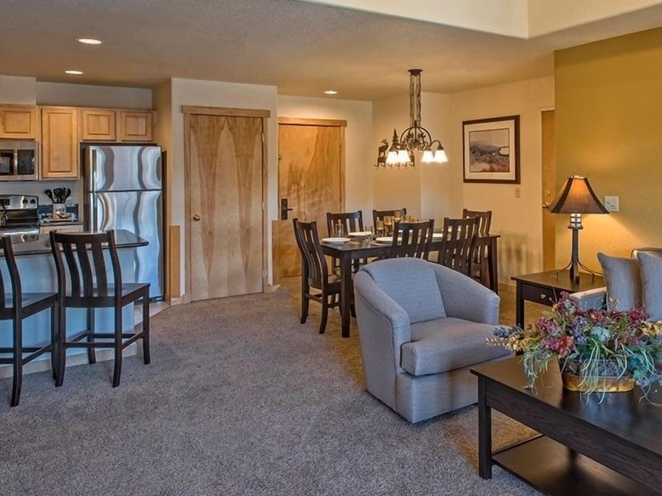 Entry door, dining area, full kitchen and living area.