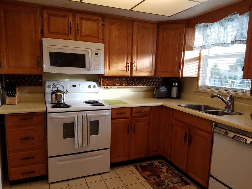 Kitchen with refrigerator, microwave, dishwasher and pantry cabinet