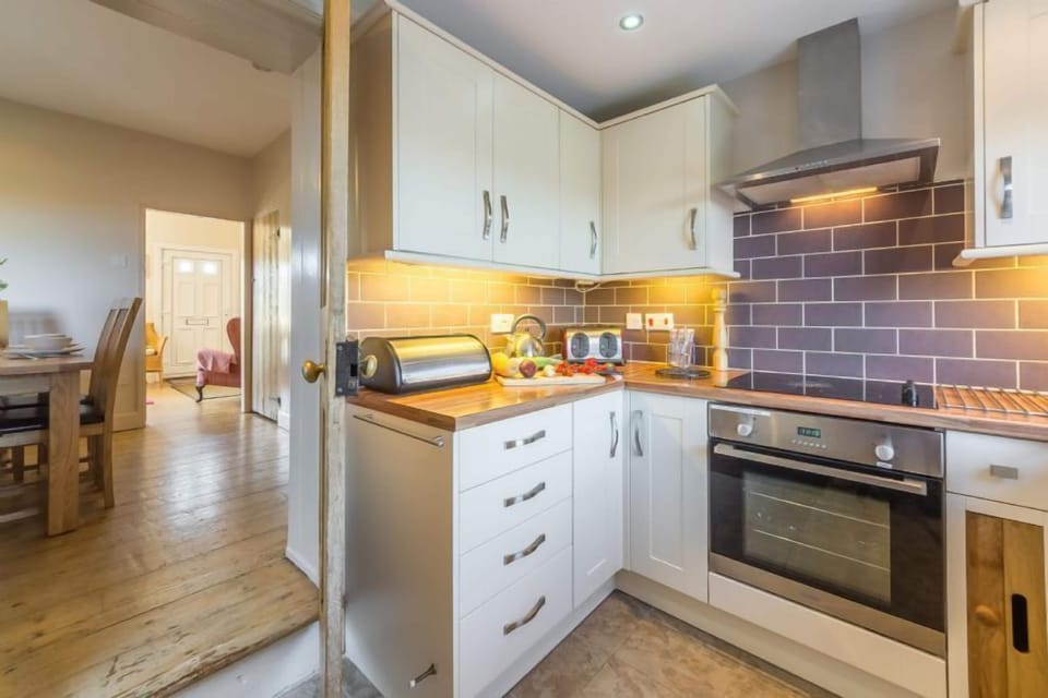 Ground floor: Kitchen, leading to dining room and sitting room