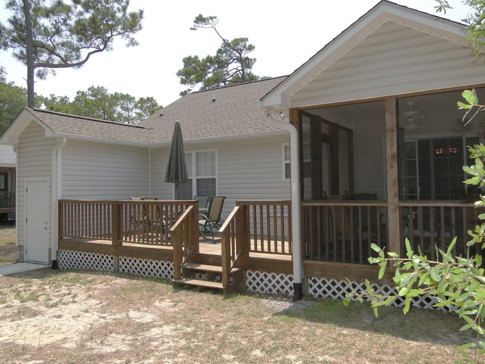Back of house with table and chairs for 6.  Plus a bench and rocking chairs.
