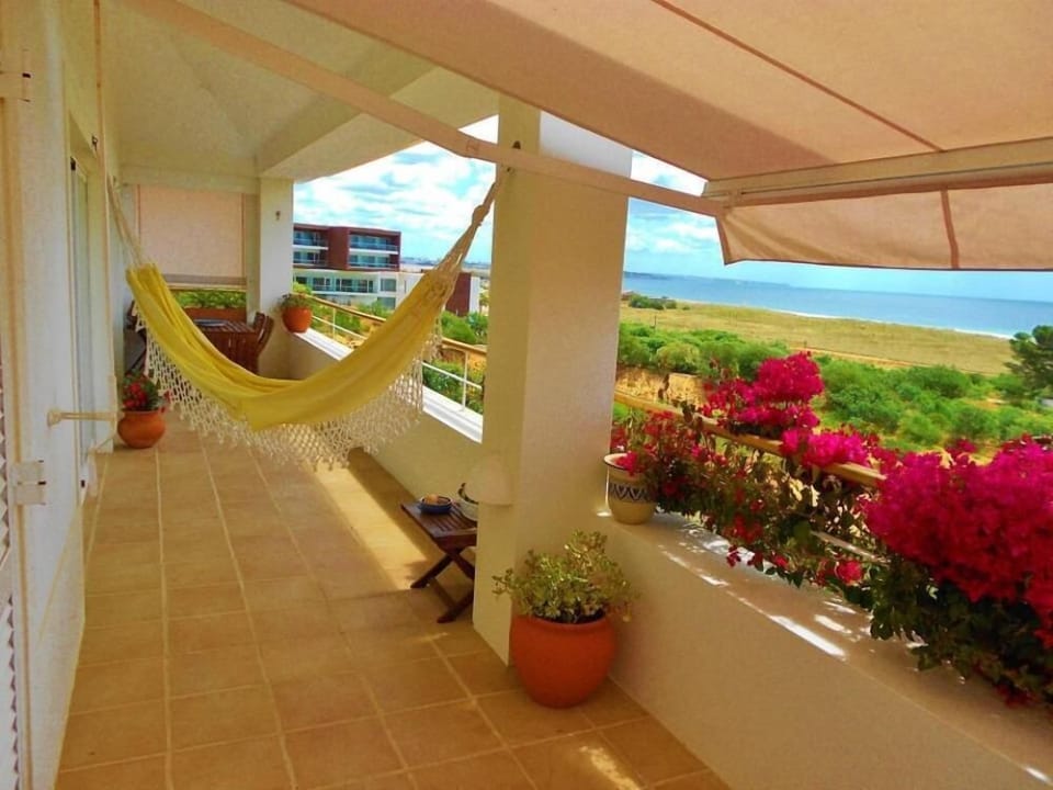 Balcony with sun lounger, awning, hammock, dining area and fantastic sea views