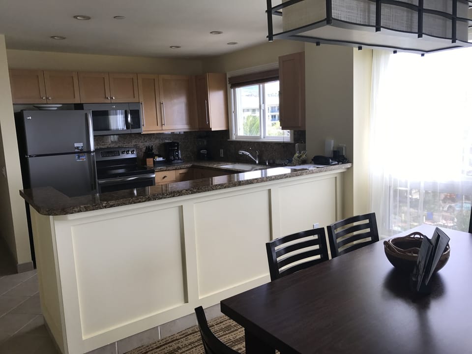 View of full size kitchen off of dining area and living room
