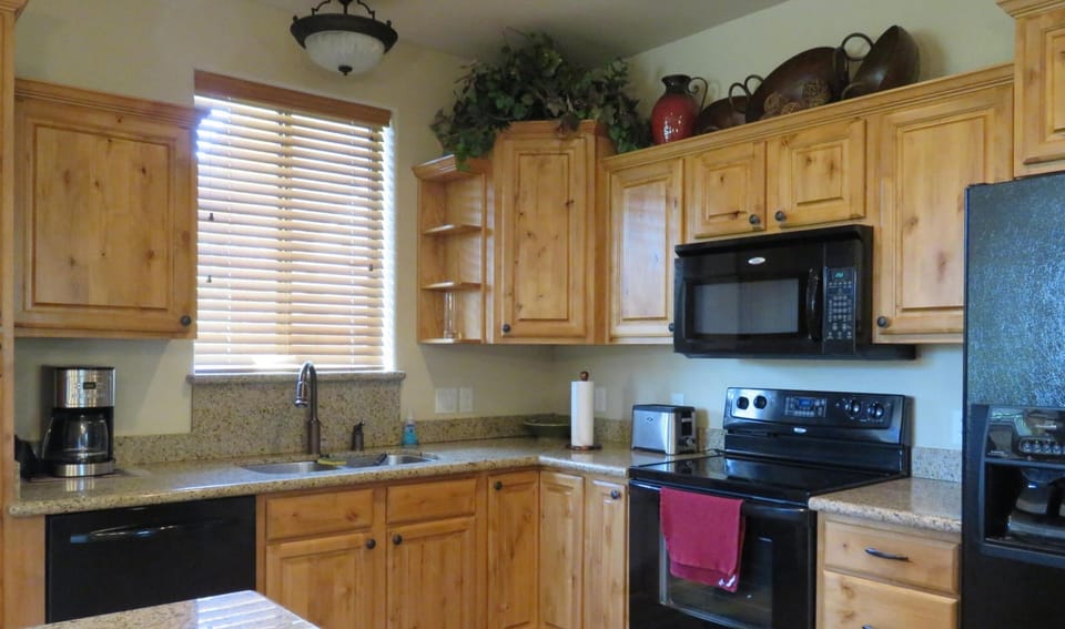 A full kitchen stocked up with everything one would need for an extended stay.
