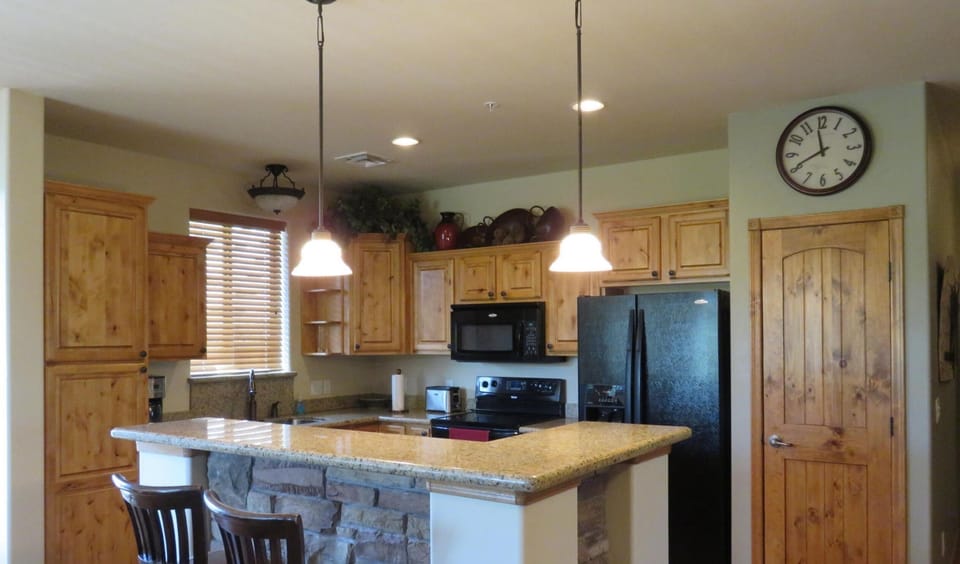 An open concept kitchen with a breakfast bar.