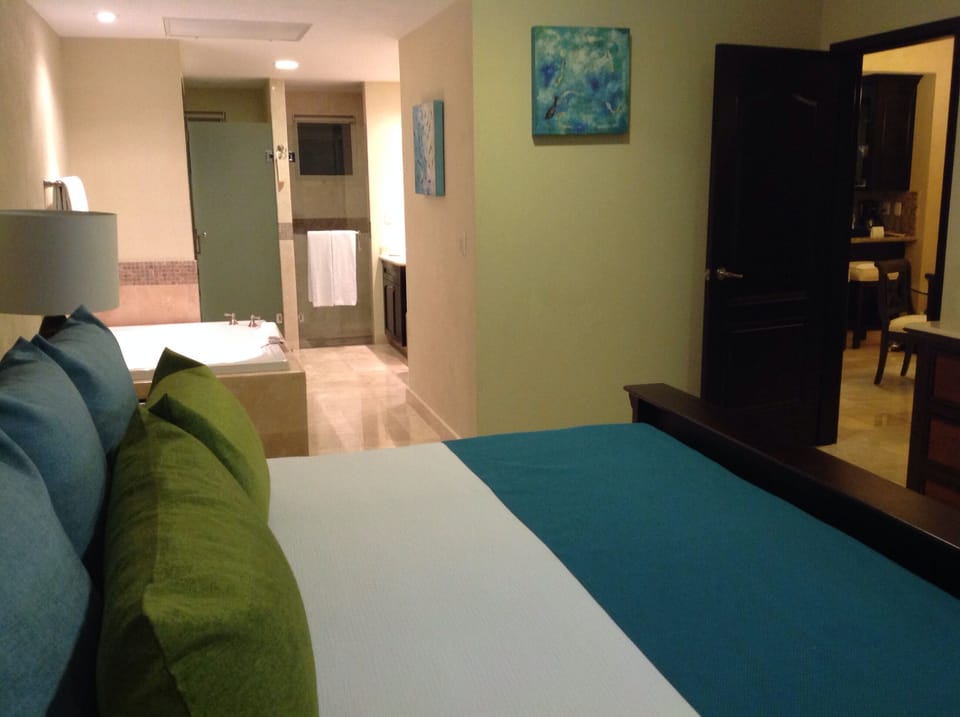 Master Bedroom with private bathroom, double vanity, jetted tub, shower, & safe