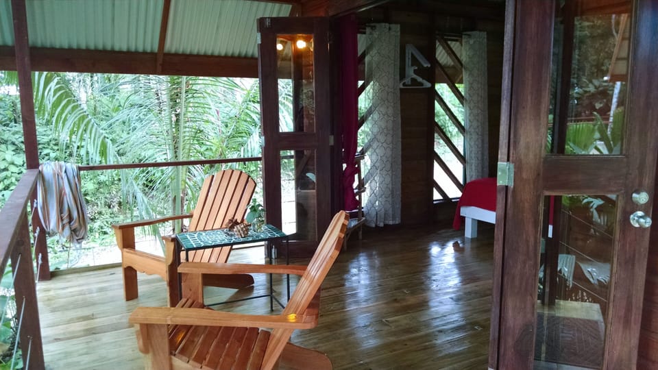 View of handmade, custom Adirondack chairs, hammock and large deck to relax on.