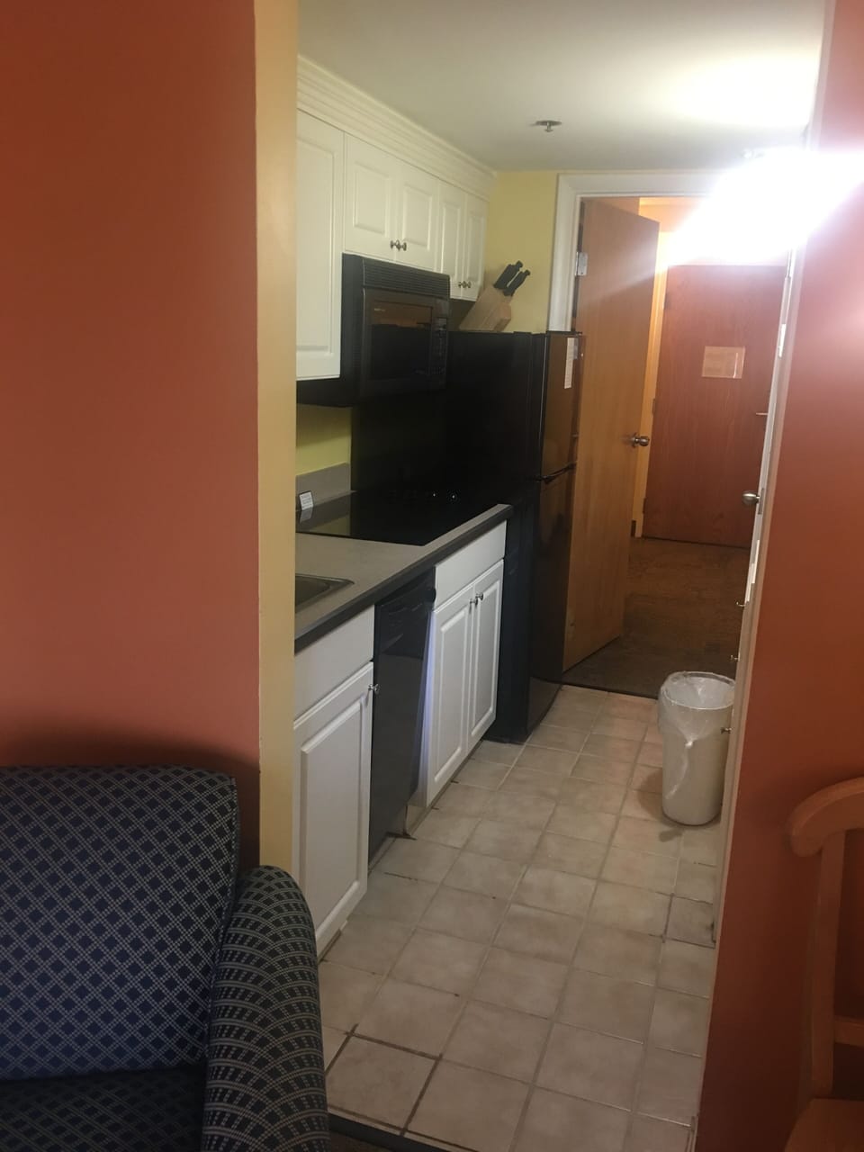 Kitchen with cooktop, combo convection oven, and refrigerator. Service for six.