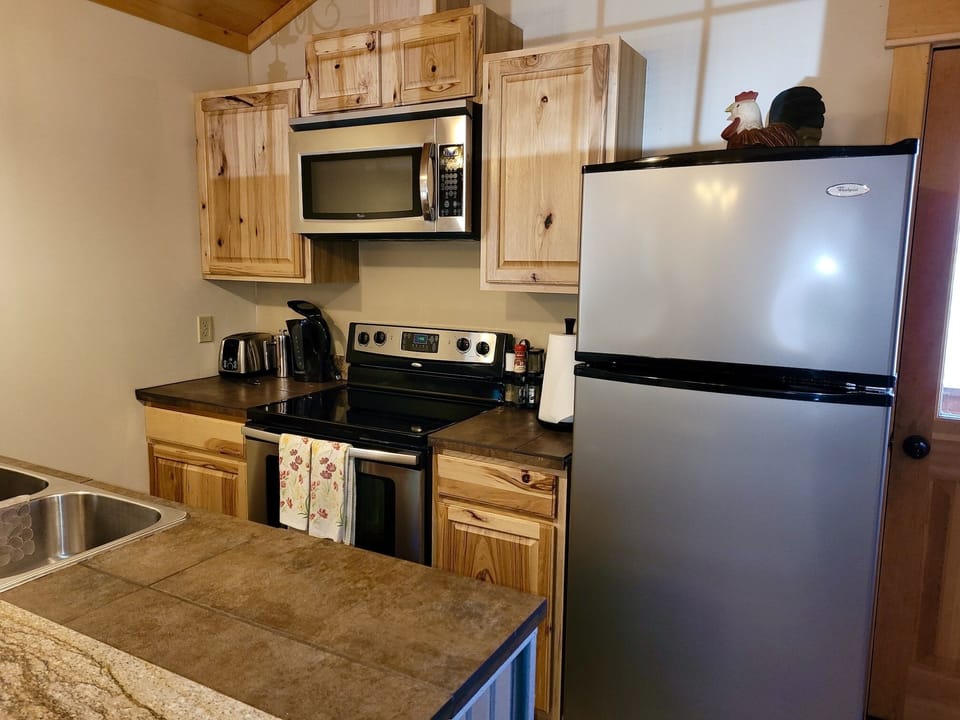 The kitchen is equipped with all new appliances, including a dishwasher. 