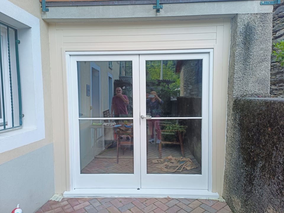 Double doors below balcony for extra privacy, space and storage.