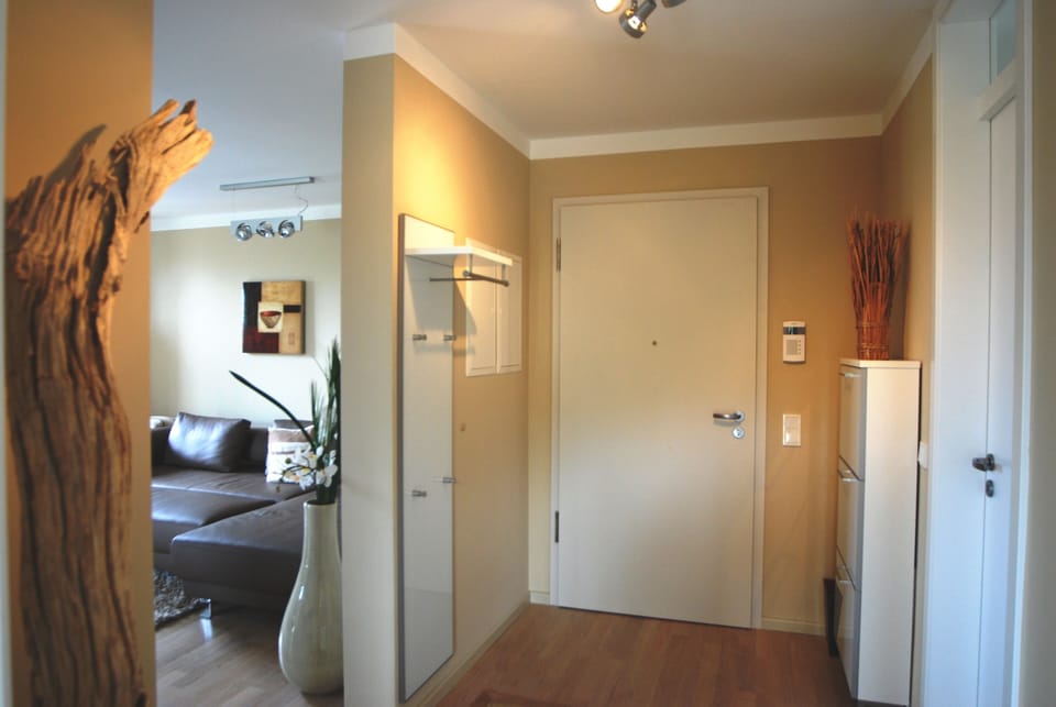 hallway with a coar rack and  a shoe box