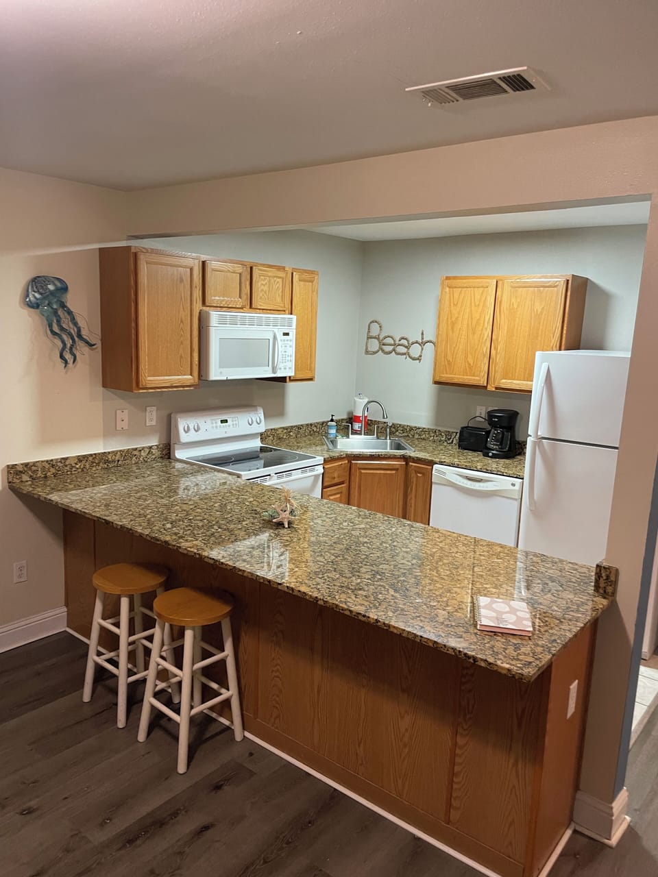 Kitchen with refrigerator, stove/oven, microwave, dishwasher, pots/pans/utensils