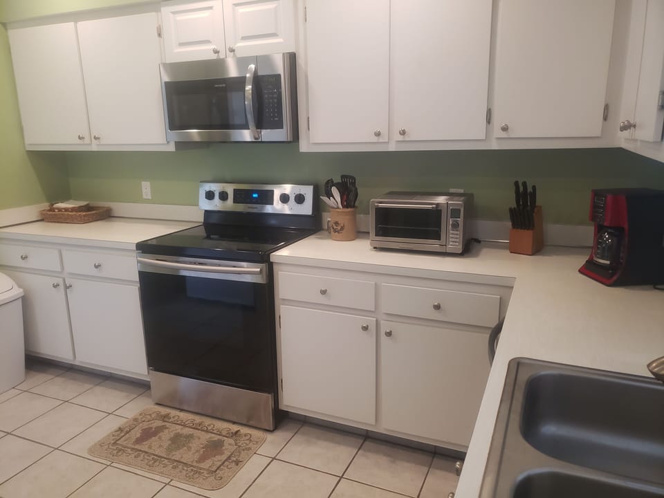 New electric stove and microwave to complement the other appliances.