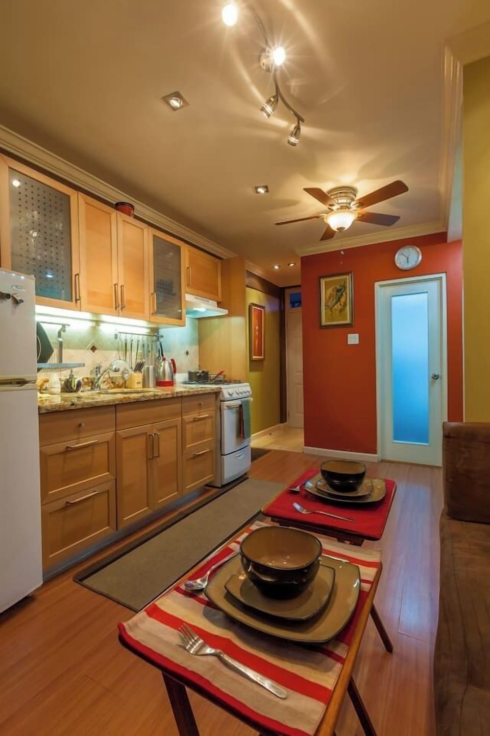 Bright kitchen w/ wood cabinets, tiled backsplash & everything set for easy meals at home