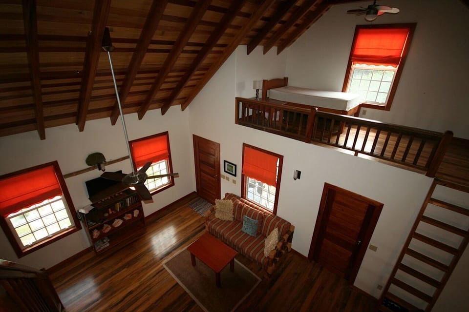 A captains loft with a twin bed looks out on the street below.