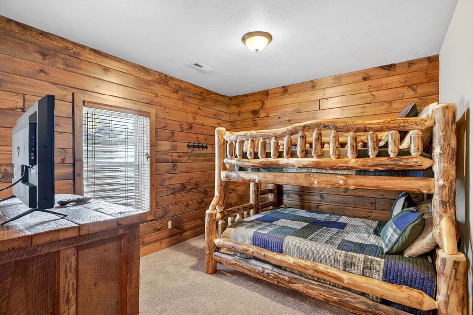 Lower-level bunk room with full over queen bunk bed