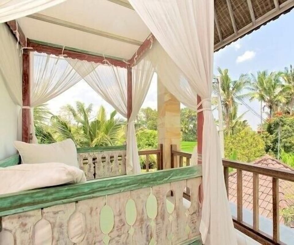Pooer bedroom wiwth balcony looking out to the ricefields