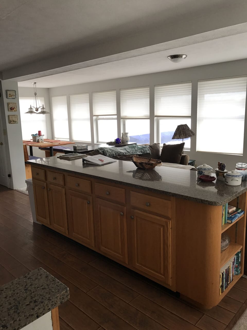 Kitchen island with view of lake and dining room on left and living room on righ