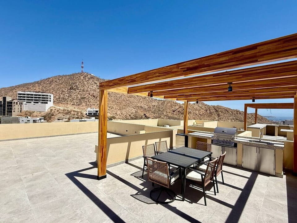 Rooftop lounge area with comfortable seating and breathtaking mountain views.