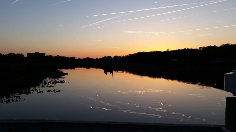 From the sound side dock at sunset.  Contrails in the water.