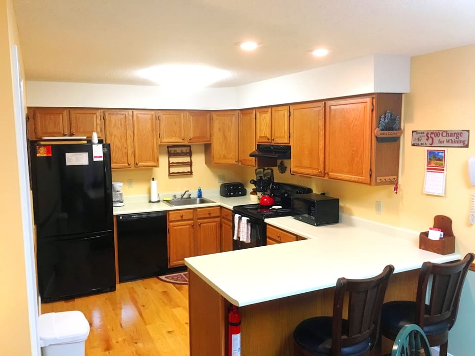 Fully equipped kitchen with additional counter seating.