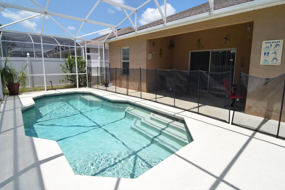 Beautiful south-facing pool with shaded lounge area, loungers, no rear neighbors