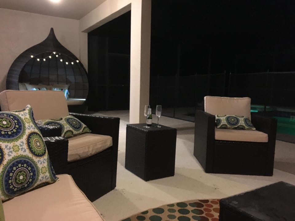 Enjoy the night breeze in the relaxing furniture, custom cabana and outdoor TV.