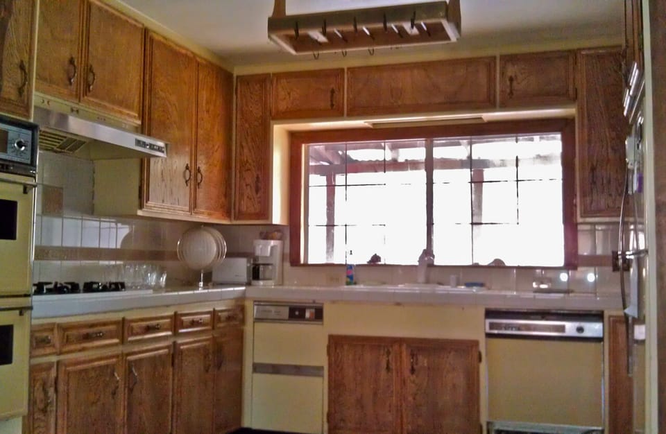 Spacious kitchen offers forest views, original oak cabinets, and new appliances.