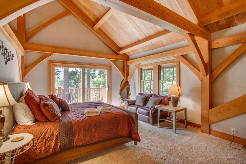 Upstairs master bedroom features a private deck with mountain view