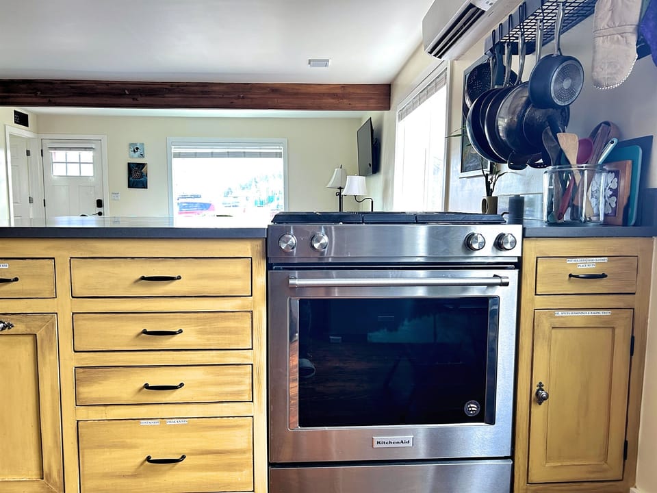 Open kitchen work space with barstools on the othe side.