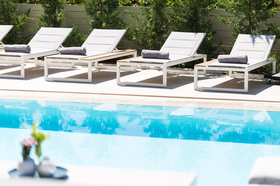 The pool terrace is equipped with sun beds and umbrellas