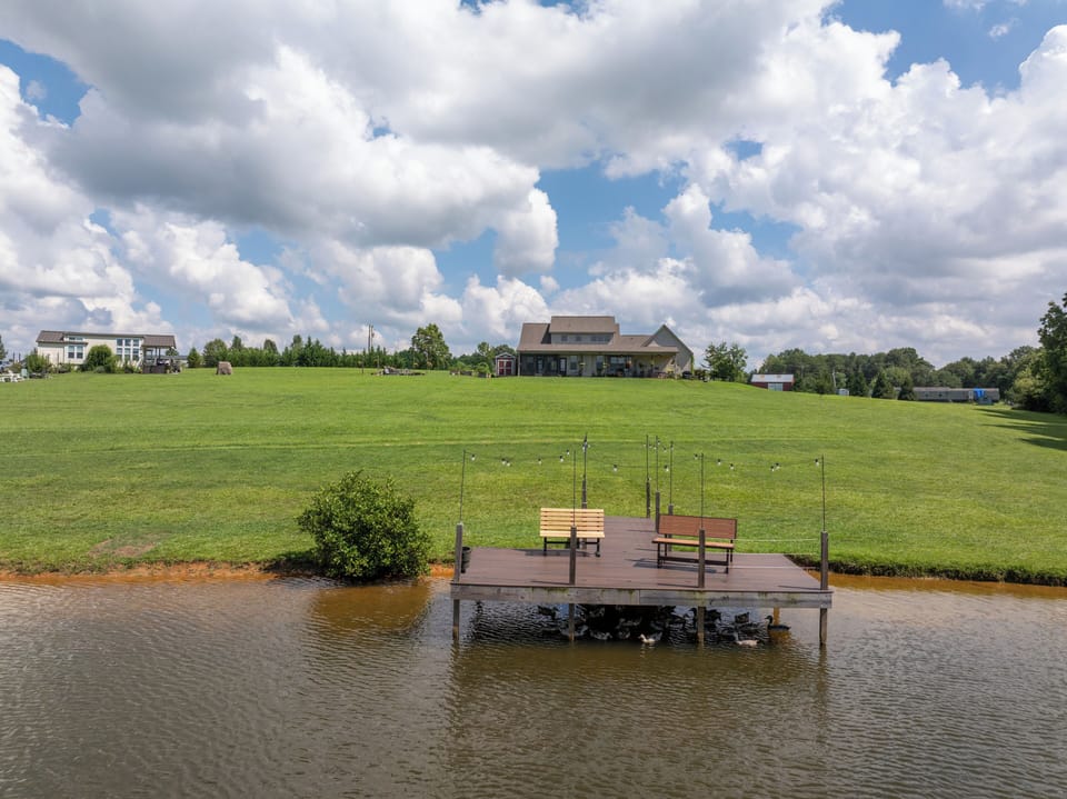 Pond, open fields, and mountain views frame your peaceful country stay.