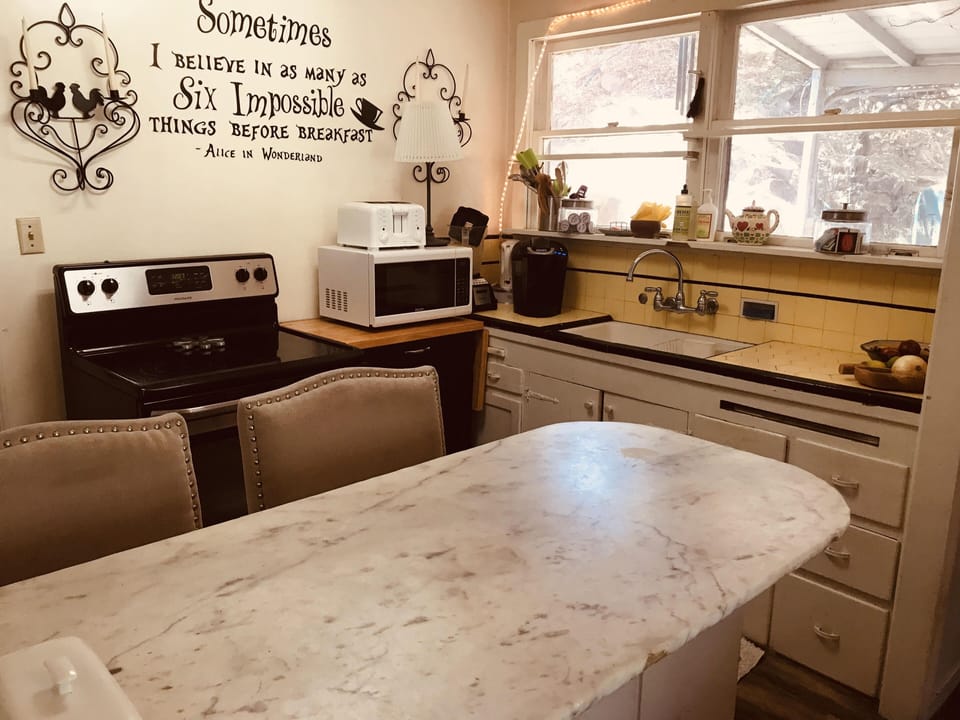 Kitchen, stove, fridge, microwave, toaster, coffee maker, and blender