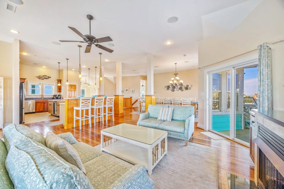 Relax in your spacious open-concept living area with gleaming hardwood floors, soaring ceilings, and seamless kitchen flow.
