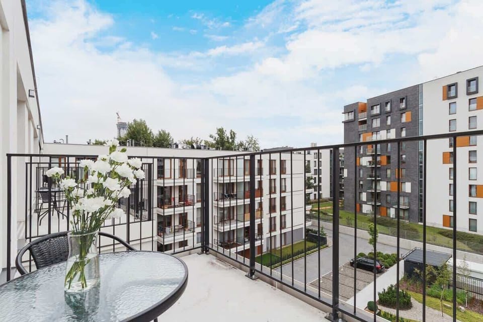 Furnished balcony with green surroundings. 