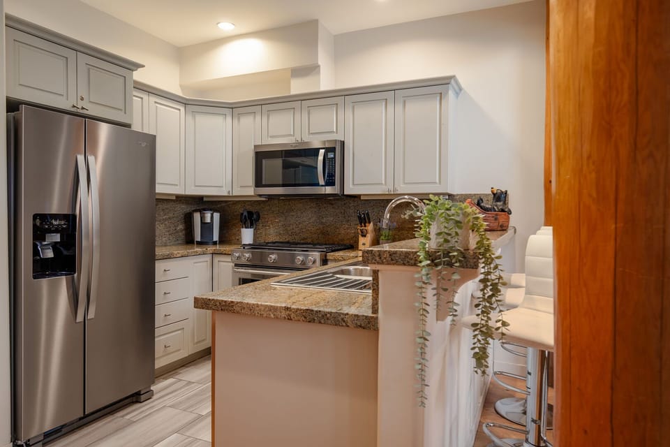 Fully equipped chef's kitchen with stainless steel appliances and mountain charm.