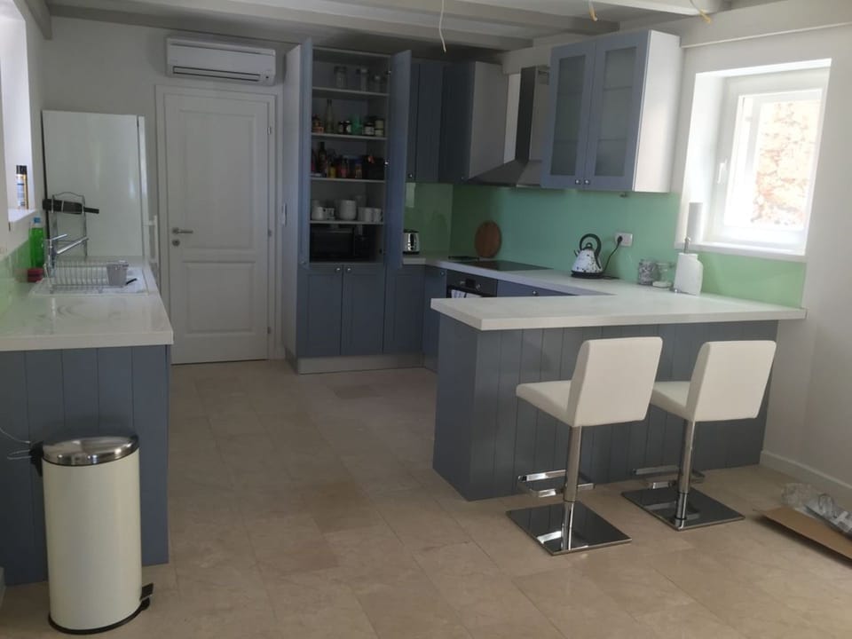 The main kitchen is well stocked with crockery, lovely glassware and utensils