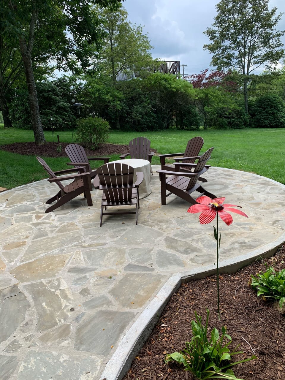 Stone patio, 6 Adirondack chairs, and propane gas firepit