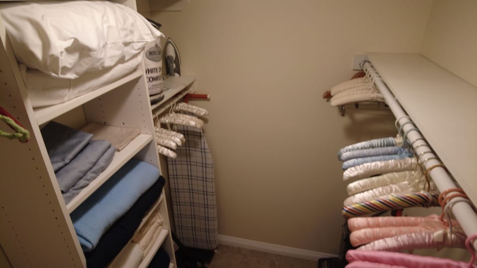 Large walk-in Closet with lots of hangers right off the bathroom