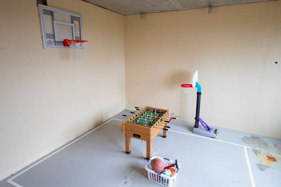 Play around on the foosball table or half basketball court under the garage.