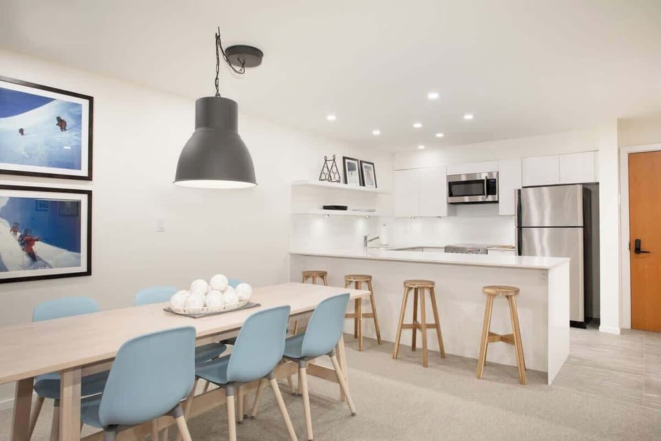 - Modern dining area with seating for family gatherings  
- Overlooks a bright open kitchen with chic bar stools  
- Ideal for shared meals and memorable conversations  
