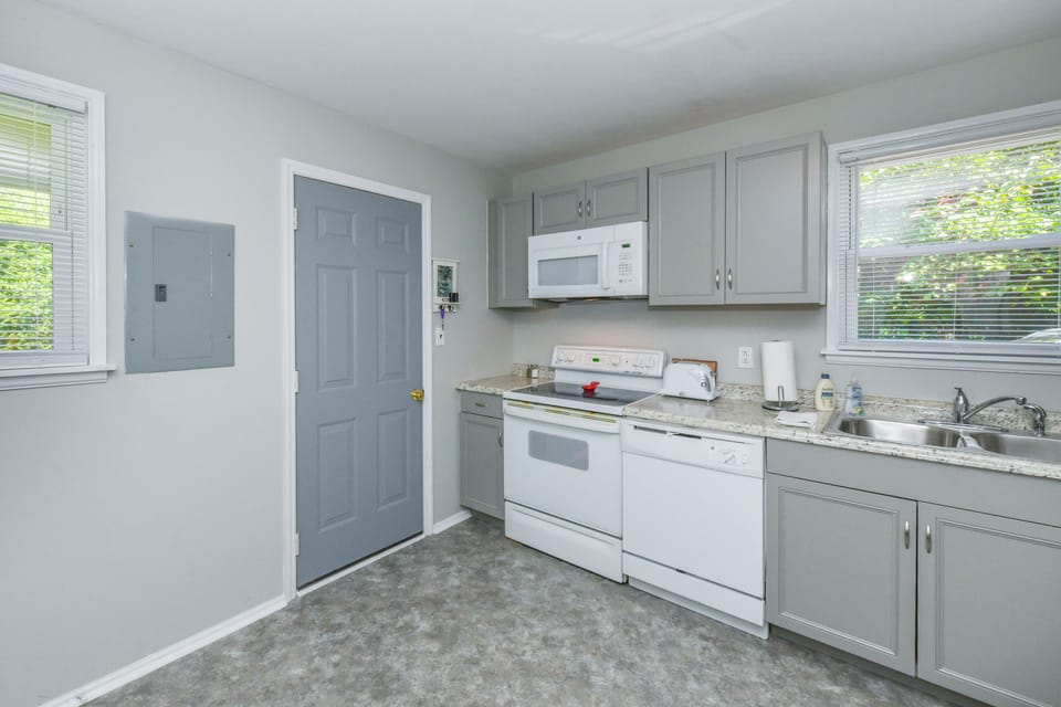 Kitchen includes washer and dryer. Backdoor to fenced yard.