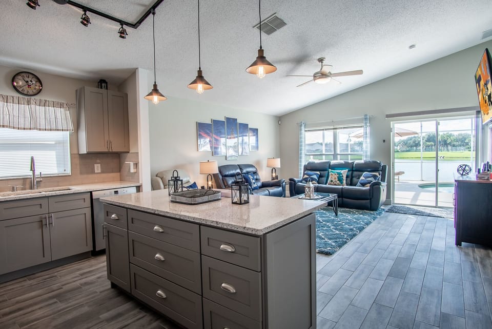 Open concept kitchen and living area with island seating.