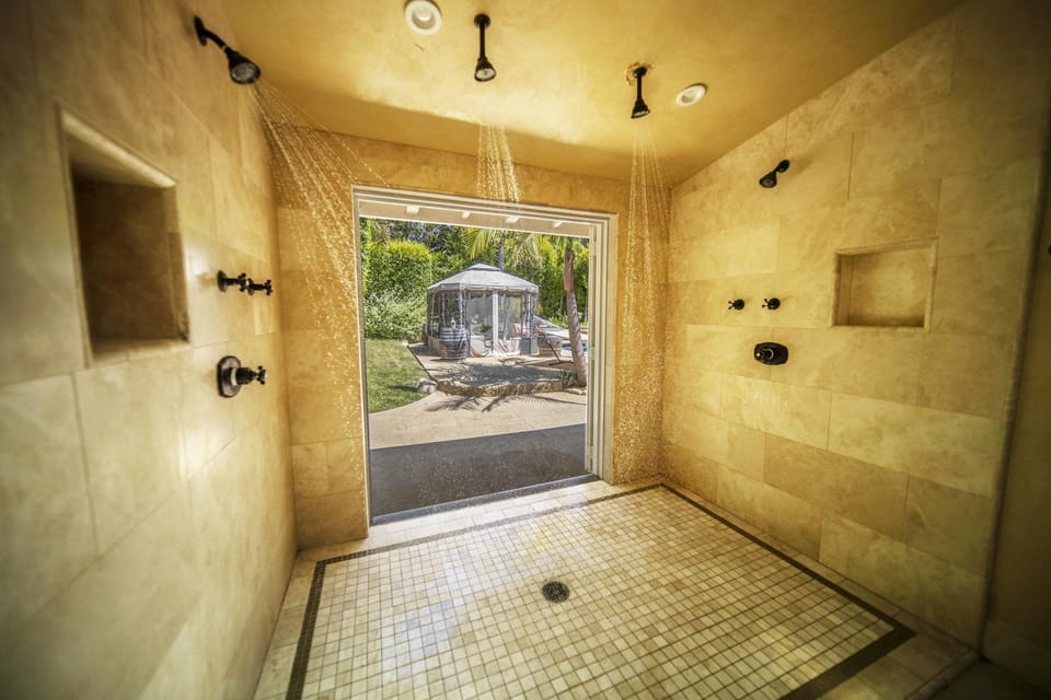 Master bath with unique quad head multi angle shower experience. (Doors close)