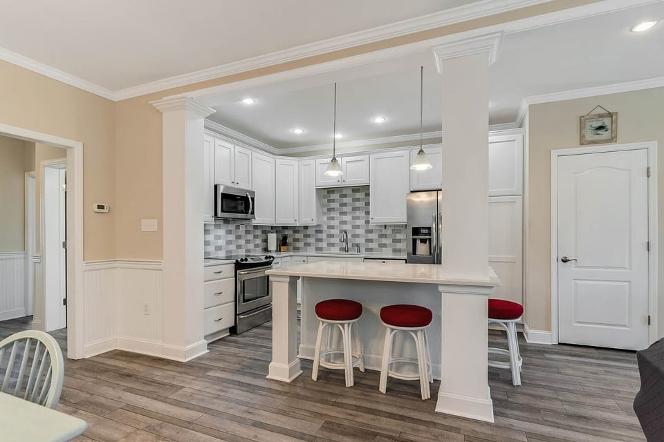 Looking into the kitchen. Setting around large kitchen island.